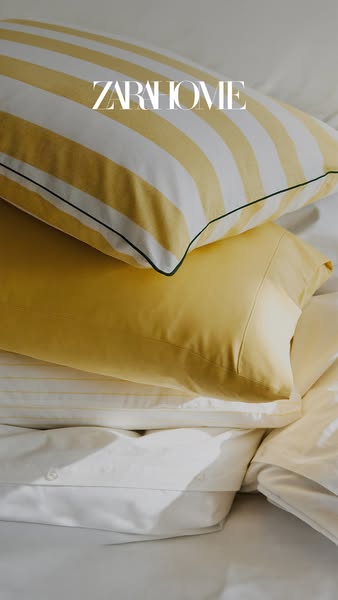A close-up lifestyle shot showcases Zara Home pillows and bedding. The pillows are arranged on a bed, and the overall st