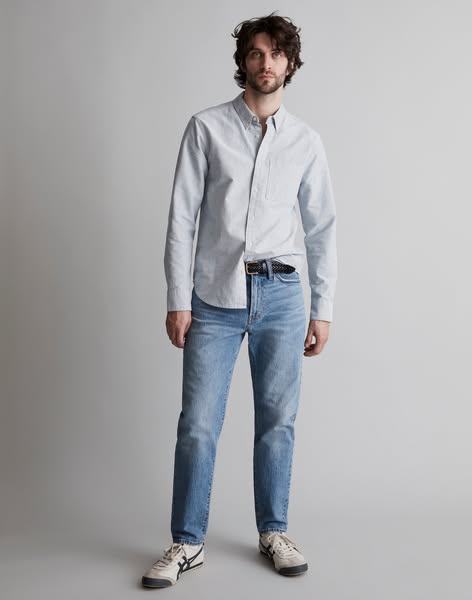 This ad features a man wearing a light blue button-down shirt and jeans. The ad is likely promoting the shirt and/or jea
