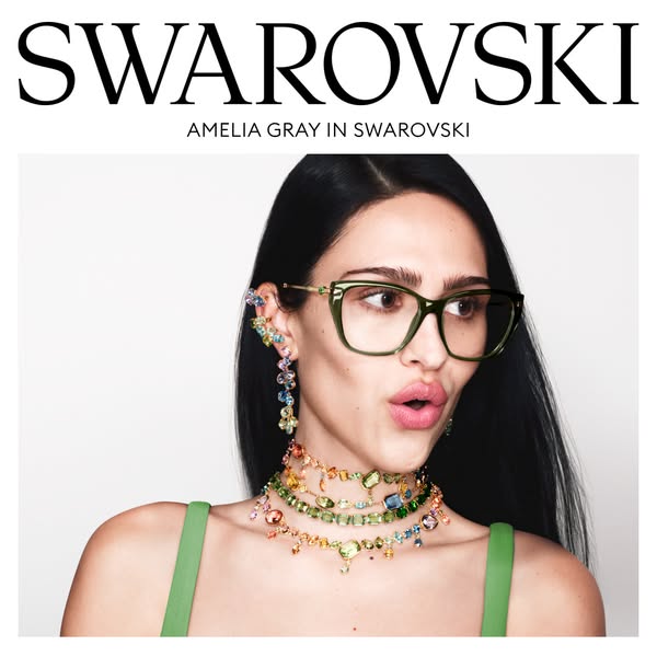 An image promoting Swarovski jewelry and eyewear. The ad features model Amelia Gray wearing jewelry and glasses from the