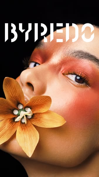This Byredo image ad features a close-up shot of a model with artistic makeup and a flower, highlighting the brand's