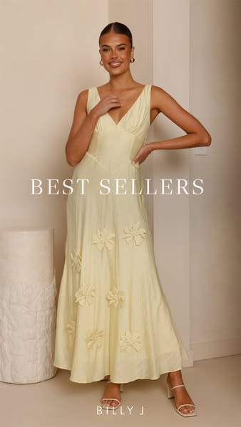 This image ad features a woman modeling a light yellow dress with floral detailing while standing in front of a neutral-