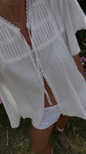 This image ad features a woman wearing clothing likely sold by the advertiser. The focus of the ad is the white blouse t