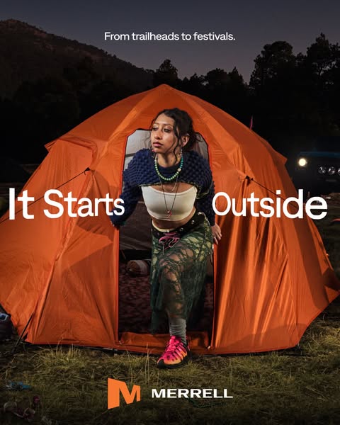 This image ad from Merrell features a woman emerging from an orange tent at dusk, promoting the brand's association 