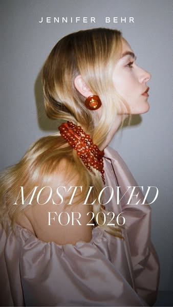 This ad for Jennifer Behr features a woman wearing a hair accessory and earrings from the brand. The ad highlights the b