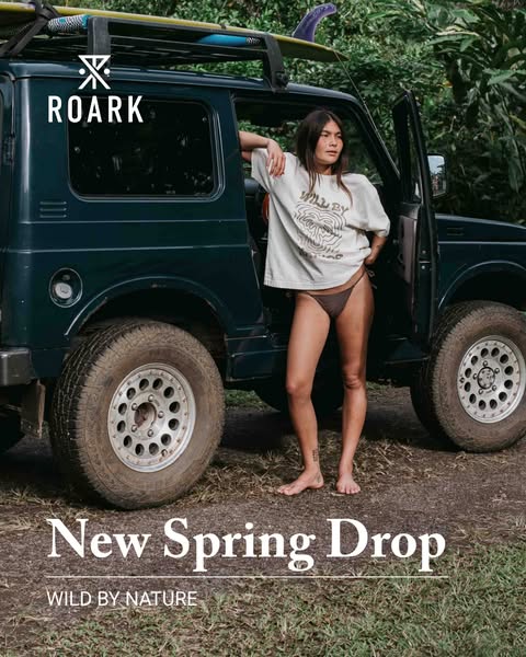 This ad for ROARK features a woman standing next to a jeep. The ad is promoting the brand's new spring drop.