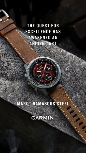 This image ad showcases the Garmin MARQ Damascus Steel watch. The ad features close up shot of the watch on a rock surfa