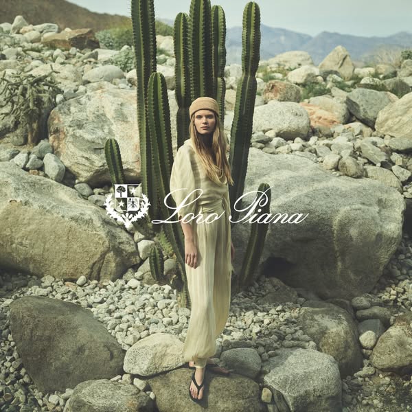 This ad features a person wearing Loro Piana clothing in a desert-like landscape. The ad showcases the brand's luxur