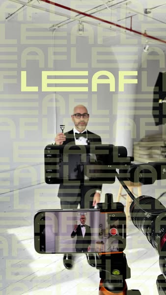 This ad shows a man in a tuxedo holding a Leaf razor while on a film set. The ad is shot from behind the camera, giving 