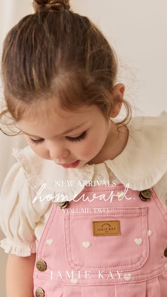 This ad promotes Jamie Kay's Homeward Volume Two collection, featuring a young girl wearing a pink overall dress wit