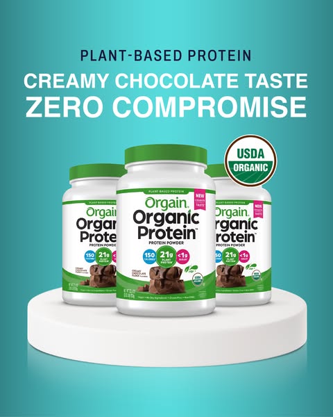 This ad features three containers of Orgain Organic Protein Powder in creamy chocolate flavor on a white platform agains