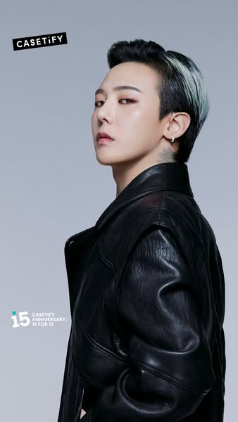 This ad features K-pop star G-Dragon promoting CASETiFY's 15th-anniversary collection. The image focuses on G-Dragon
