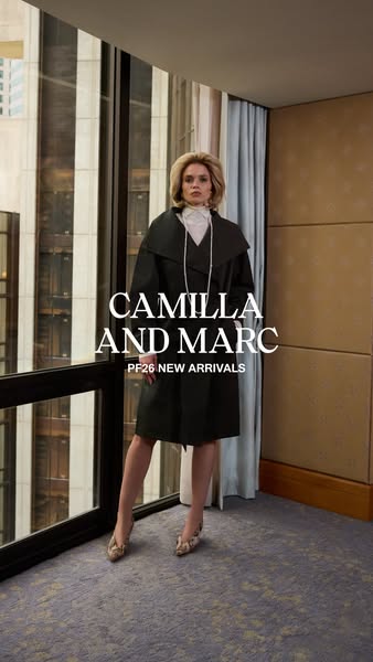 This ad showcases a woman posing in front of a window wearing a Camilla and Marc coat from the new PF26 collection.