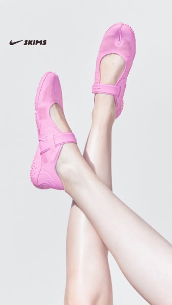 This ad showcases a pink SKIMS shoe with a split toe design. The shoe is displayed on a person's feet against a plai