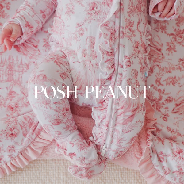 This ad promotes Posh Peanut clothing. It features an overhead shot of a baby wearing a pink and white floral romper and