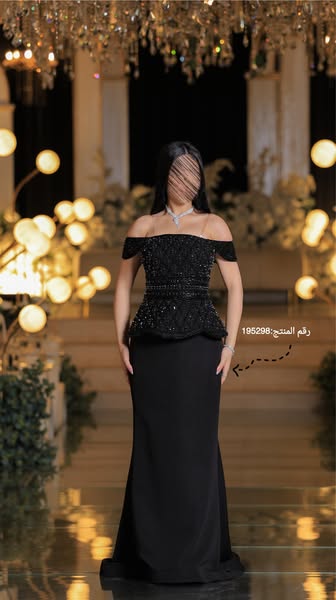 This is an image ad for a black off-the-shoulder dress. The dress is the main focus of the ad, and the background consis