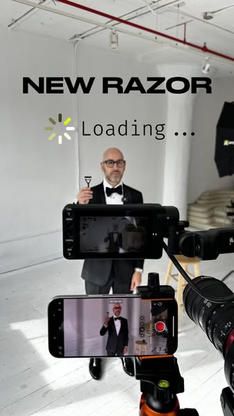 This ad shows a man in a tuxedo holding a razor. The ad is shot behind the scenes, showing the camera equipment used to 