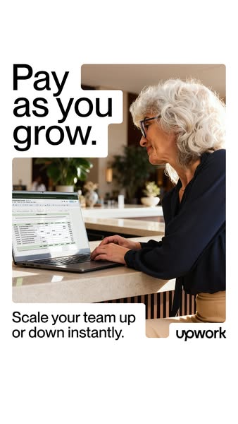 This image ad for Upwork features an older woman working on a laptop in what looks like a hotel or co-working space. The
