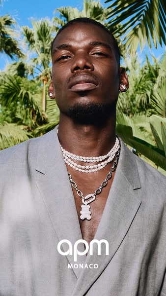 Image showcasing jewelry worn by Paul Pogba. The jewelry features white pearls, silver, and a bear pendant.