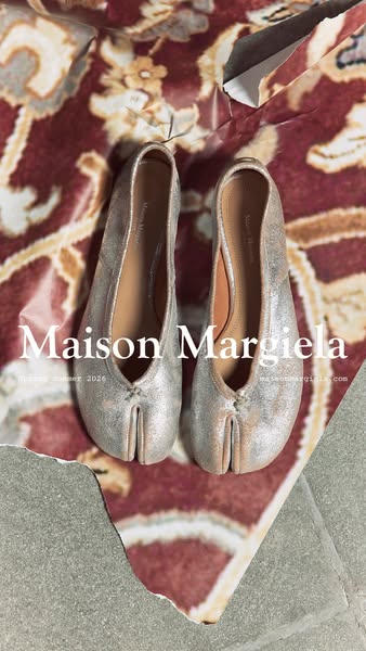 The ad features a pair of Maison Margiela Tabi ballerina shoes. The shoes are presented on a textured background, emphas