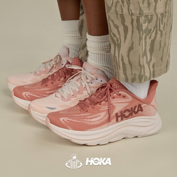 This ad showcases three Hoka running shoes in varying shades of pink. The shoes are displayed in a row, with a person we