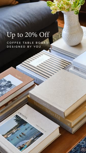 An image showing a stack of coffee table books next to a vase of flowers, with an overlay promoting a 20% discount on co