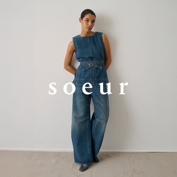 This image ad showcases a brand called soeur. A woman models a denim outfit consisting of a top and pants in front of a 