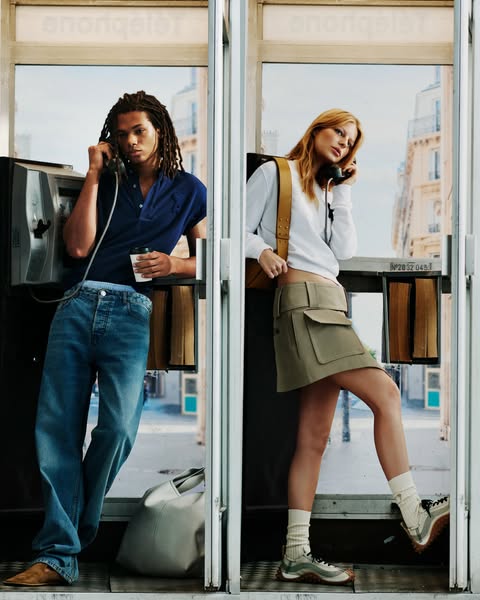 This ad features two people inside telephone booths wearing jeans, sweatshirts, skirts, socks and sneakers. It could be