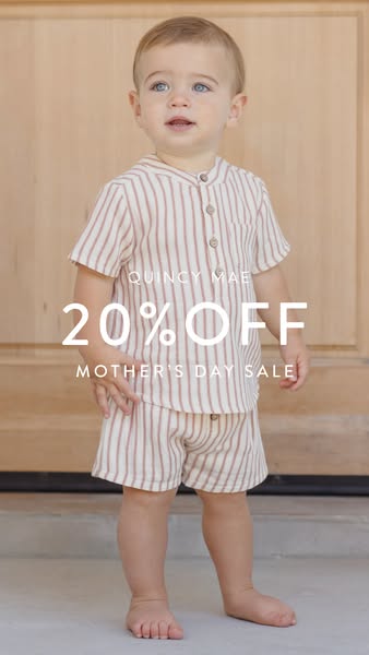 A full shot of a baby wearing a striped shirt and shorts set, with a sale offer displayed across the image.