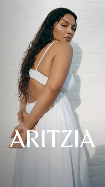 This ad features a woman wearing an Aritzia dress in front of a white background. The focal point is the dress, which is