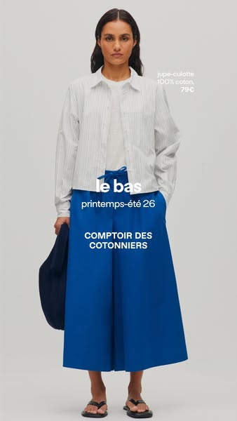 The ad features a person modeling a pair of blue wide-legged pants from Comptoir des Cotonniers as part of their spring/