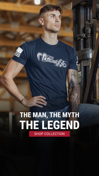 This image ad showcases a male model wearing a navy blue t-shirt with a wrench graphic. The ad intends to celebrate hard