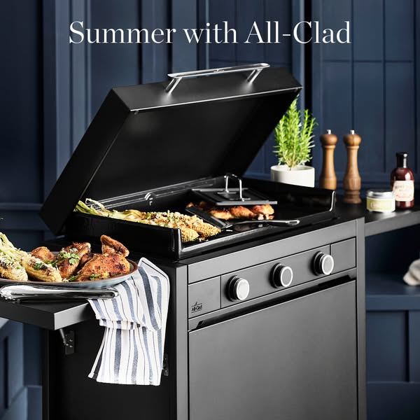 This image ad showcases an All-Clad griddle with various foods prepared on it, highlighting summer cooking.