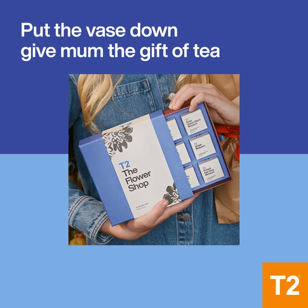 The ad promotes T2 The Flower Shop tea as a gift for mothers. It shows a woman holding a box set of teas, suggesting it 