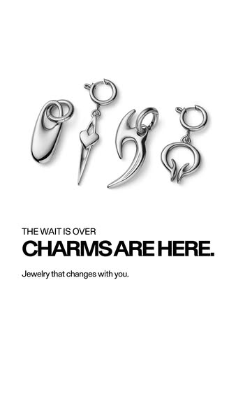 This ad showcases four different silver-colored charms. The ad highlights the arrival of new charms with the tagline &qu