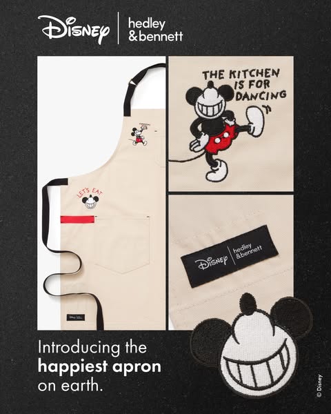 A promotional image for a Hedley & Bennett apron designed in collaboration with Disney. The apron is light tan with 