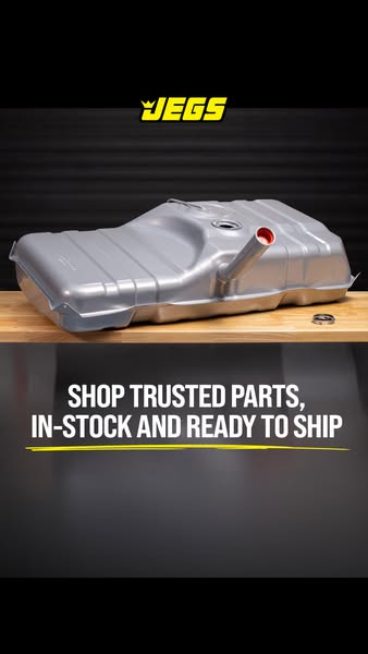 This ad features a silver-colored automotive fuel tank sitting on a wooden surface. The text overlay highlights the bran