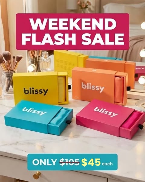 An image ad that features a collection of Blissy silk pillowcases in colorful packaging placed on a white vanity. The ad