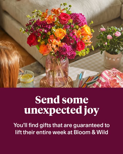 This image ad for Bloom & Wild uses a flatlay shot of a bouquet of flowers, potted plant, and other desktop accessor