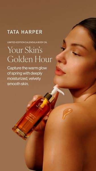 A close up of the Tata Harper Calendula Body Oil being applied to the model's body, highlighting its moisturizing an