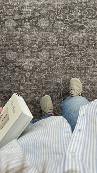 This image ad shows a rug product in a real-life setting, implying that it is suitable for everyday use.