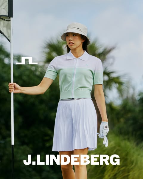 A fashion ad that shows a female golfer wearing J.Lindeberg brand clothing.