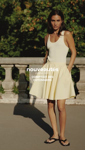 This ad showcases a woman wearing apparel from Comptoir des Cotonniers. The ad features a tank top and skirt from their 
