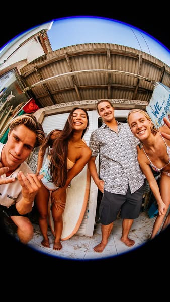 Group photo of friends with surfboards.