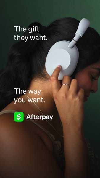 This ad features a woman wearing white headphones and highlights the option to pay with Afterpay.