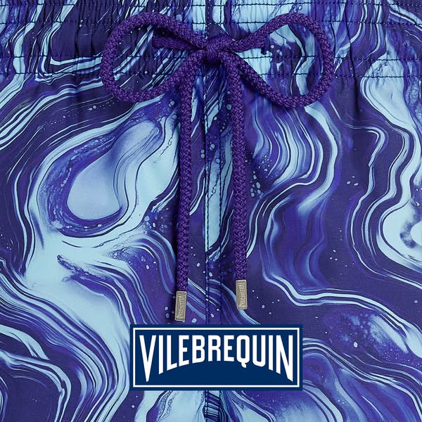 This ad features a close-up shot of Vilebrequin men's swim trunks, showcasing the brand's vibrant and high-quali