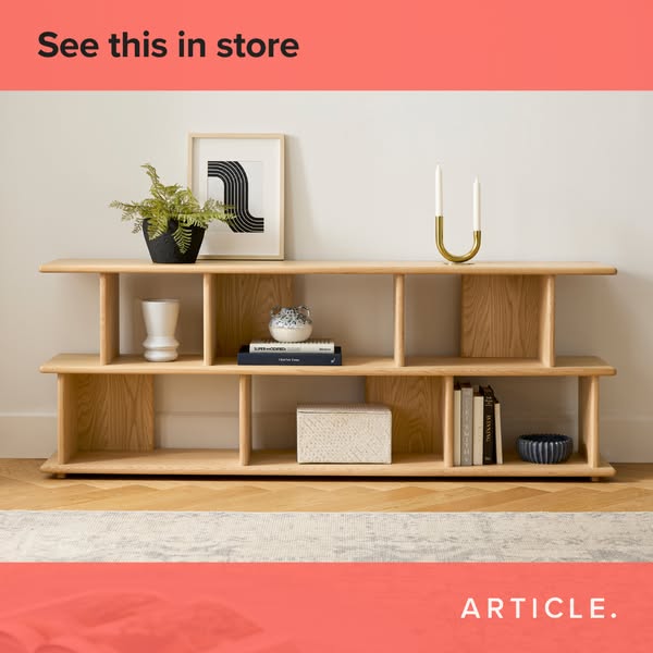 This ad showcases a wooden shelving unit from Article. The ad encourages viewers to see the product in store.