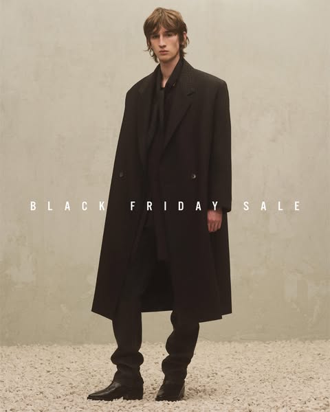 This image ad promotes a Black Friday sale. It features a man wearing a long, dark overcoat, styled in a way that sugges