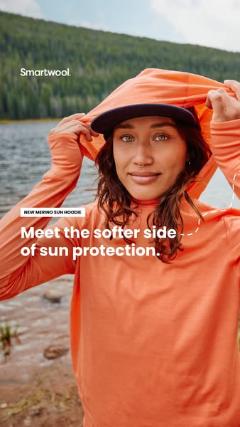 This Meta image ad showcases Smartwool's new merino sun hoodie. The ad features a woman wearing the hoodie outdoors,