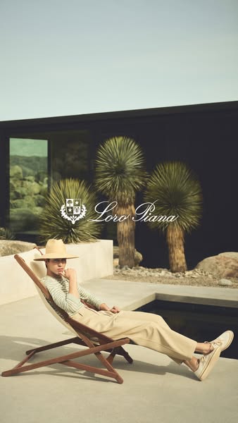 This Loro Piana ad features a stylish man in a hat and khaki-colored suit reclining in a chair by a pool, with palm tree