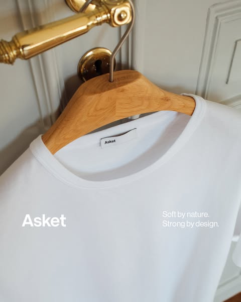 This ad showcases a white t-shirt from Asket, emphasizing its quality and design. The ad uses a minimalist approach with